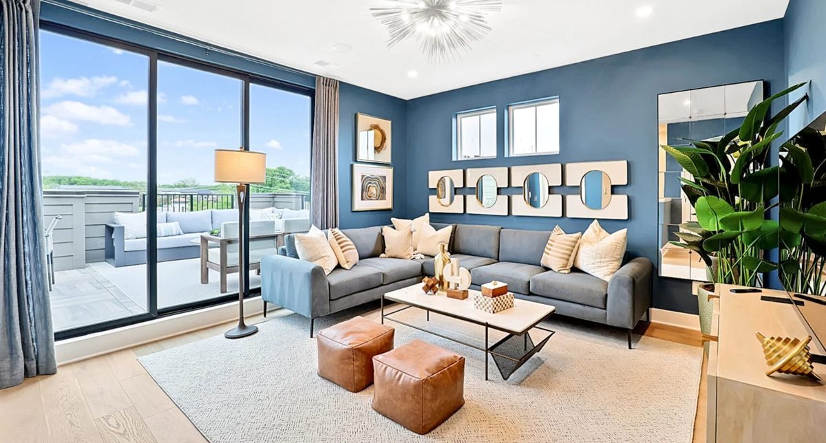 Rooftop loft living room opening to a terrace in an EYA townhome